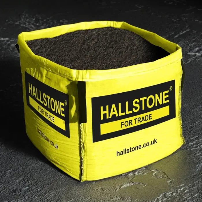 Hallstone Blended Loam Topsoil Bulk Bag on Black Studio Background with Bright Yellow Builders Bag