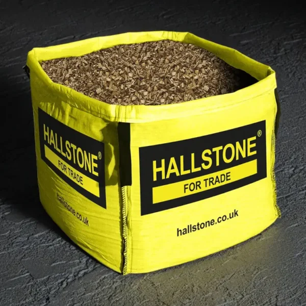 Hallstone Wood Chippings in Bulk Bag Studio Black Background with Bright Yellow Bag